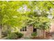 Home exterior with stone facade and well-maintained landscaping under mature trees at 2940 Ulster St, Denver, CO 80238