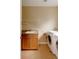 Functional laundry room with sink, cabinet, and modern washer and dryer at 2940 Ulster St, Denver, CO 80238