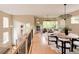 Open-concept living area with hardwood floors, natural light, and a fireplace at 2940 Ulster St, Denver, CO 80238