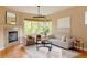 Bright living room with contemporary furnishings, fireplace, and large windows showcasing the outdoors at 2940 Ulster St, Denver, CO 80238