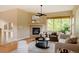Cozy living room with fireplace, neutral decor, and a large window offering plenty of natural light at 2940 Ulster St, Denver, CO 80238