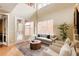 Open living room with high ceilings, staircase, and comfortable seating at 2940 Ulster St, Denver, CO 80238