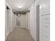 Long view of finished basement hallway with painted walls and gray carpeting at 2692 S Pennsylvania St, Denver, CO 80210