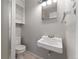 Half bathroom with a sink and a toilet next to the shower at 2692 S Pennsylvania St, Denver, CO 80210