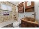 Rustic bathroom featuring a decorative wood sink, accent wall tiles and a shower over tub at 2692 S Pennsylvania St, Denver, CO 80210