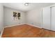 Bedroom with hardwood floors, closet, and a window overlooking the yard at 2692 S Pennsylvania St, Denver, CO 80210