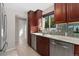 Updated kitchen with stainless steel appliances, granite countertops, and bright natural light from the window at 2692 S Pennsylvania St, Denver, CO 80210
