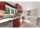 Bright eat-in kitchen features stainless steel appliances, tile backsplash, and a cozy dining area at 2692 S Pennsylvania St, Denver, CO 80210