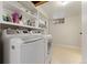 Bright laundry room featuring newer front load washer, dryer, and built-in storage at 2692 S Pennsylvania St, Denver, CO 80210