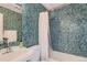 This stylish bathroom features mosaic tile walls, modern fixtures, and a clean, inviting design at 500 E 11Th Ave # 305, Denver, CO 80203