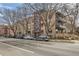 A full view of the multi-story brick apartment building nestled in a vibrant urban setting at 500 E 11Th Ave # 305, Denver, CO 80203