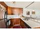 A contemporary kitchen has sleek stainless steel appliances, modern lighting, and ample counter space at 500 E 11Th Ave # 305, Denver, CO 80203