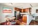 A modern eat-in kitchen has wood cabinets, stainless appliances, and an adjacent dining area at 500 E 11Th Ave # 305, Denver, CO 80203