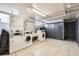 Functional laundry room featuring multiple machines and ample space for convenience at 500 E 11Th Ave # 305, Denver, CO 80203