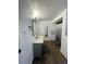 Updated bathroom featuring a modern vanity with a large mirror and new wood floors at 4995 N Beach Ct, Denver, CO 80221