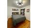 Bedroom features wood floors, natural light, a closet, and decorative wall art at 4995 N Beach Ct, Denver, CO 80221