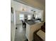 Open-concept dining room features a view of the kitchen, modern lighting, and neutral paint at 4995 N Beach Ct, Denver, CO 80221