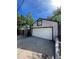 Detached garage with overhead door and driveway for parking at 4995 N Beach Ct, Denver, CO 80221