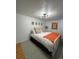 Comfortable bedroom featuring light-colored walls, modern lighting and hardwood floors at 4995 N Beach Ct, Denver, CO 80221