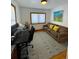 Office/flex space features wood floors, natural light, and a decorative area rug at 4995 N Beach Ct, Denver, CO 80221