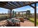 Outdoor patio with ample seating, pergola, and natural views at 12119 S Wanderlust Way, Parker, CO 80138