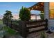 Secluded backyard featuring a stone patio, pergola, and lush garden beds, creating a tranquil outdoor space at 12119 S Wanderlust Way, Parker, CO 80138