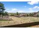 Scenic view of the backyard with rolling hills and distant homes at 12119 S Wanderlust Way, Parker, CO 80138