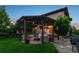 Charming backyard with pergola covered seating area, fire pit, and vibrant landscaping, perfect for outdoor entertaining at 12119 S Wanderlust Way, Parker, CO 80138