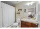 Bathroom with tile floors, warm-toned vanity, and a shower/tub combo at 12119 S Wanderlust Way, Parker, CO 80138