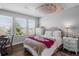 Cozy bedroom with soft lighting, decorative ceiling art, and natural light through the window at 12119 S Wanderlust Way, Parker, CO 80138