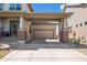This house features a spacious two-car garage with convenient carport and brick-trimmed posts at 12119 S Wanderlust Way, Parker, CO 80138