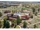 Aerial view of the community pool area, featuring pools, lounge chairs, and walking trails at 12119 S Wanderlust Way, Parker, CO 80138