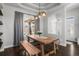 Charming dining room featuring a wooden table, bench seating, and elegant decor at 12119 S Wanderlust Way, Parker, CO 80138