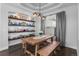 Bright dining area featuring a rustic table, wooden benches, and stylish shelving at 12119 S Wanderlust Way, Parker, CO 80138