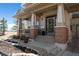 Inviting front porch with brick accents, decorative wreath, and meticulously landscaped garden beds at 12119 S Wanderlust Way, Parker, CO 80138