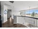 Bright hallway with hardwood floors and large windows offering beautiful views of the surrounding landscape at 12119 S Wanderlust Way, Parker, CO 80138