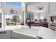 Bright open-concept kitchen with modern white cabinets, and a view of the living area and outdoor scenery at 12119 S Wanderlust Way, Parker, CO 80138