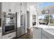 Modern kitchen with stainless steel appliances, including double ovens and a large refrigerator at 12119 S Wanderlust Way, Parker, CO 80138