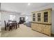 Finished basement with a kitchenette, table, TV, and sectional sofa at 12119 S Wanderlust Way, Parker, CO 80138
