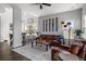 Open-concept living room with hardwood floors, and a large leather sofa at 12119 S Wanderlust Way, Parker, CO 80138