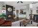 Open living area with brick fireplace, living room and kitchen island at 12119 S Wanderlust Way, Parker, CO 80138