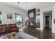 View of living room with brick fireplace, a leather couch, and a sliding door to the backyard at 12119 S Wanderlust Way, Parker, CO 80138