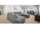 Spacious living room with a comfortable gray sectional sofa at 12119 S Wanderlust Way, Parker, CO 80138