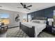 Stunning main bedroom with a king bed, accent wall, and scenic views from the surrounding windows at 12119 S Wanderlust Way, Parker, CO 80138