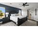 Beautiful main bedroom features an accent wall, carpet, large windows, and elegant furnishings at 12119 S Wanderlust Way, Parker, CO 80138