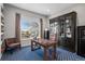 Office with large window offering great views, a desk, built-in shelves and comfortable seating at 12119 S Wanderlust Way, Parker, CO 80138