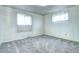 Bedroom with two windows, neutral carpet, and minimal features offers customization at 301 S Troy St, Aurora, CO 80012