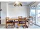 Close up of a dining table and chairs with a sliding glass door to a patio at 301 S Troy St, Aurora, CO 80012