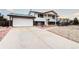 Exterior view of two-story home with driveway and attached garage at 301 S Troy St, Aurora, CO 80012