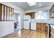 A view of the kitchen showcasing wood cabinets, white appliances, and a breakfast nook at 301 S Troy St, Aurora, CO 80012